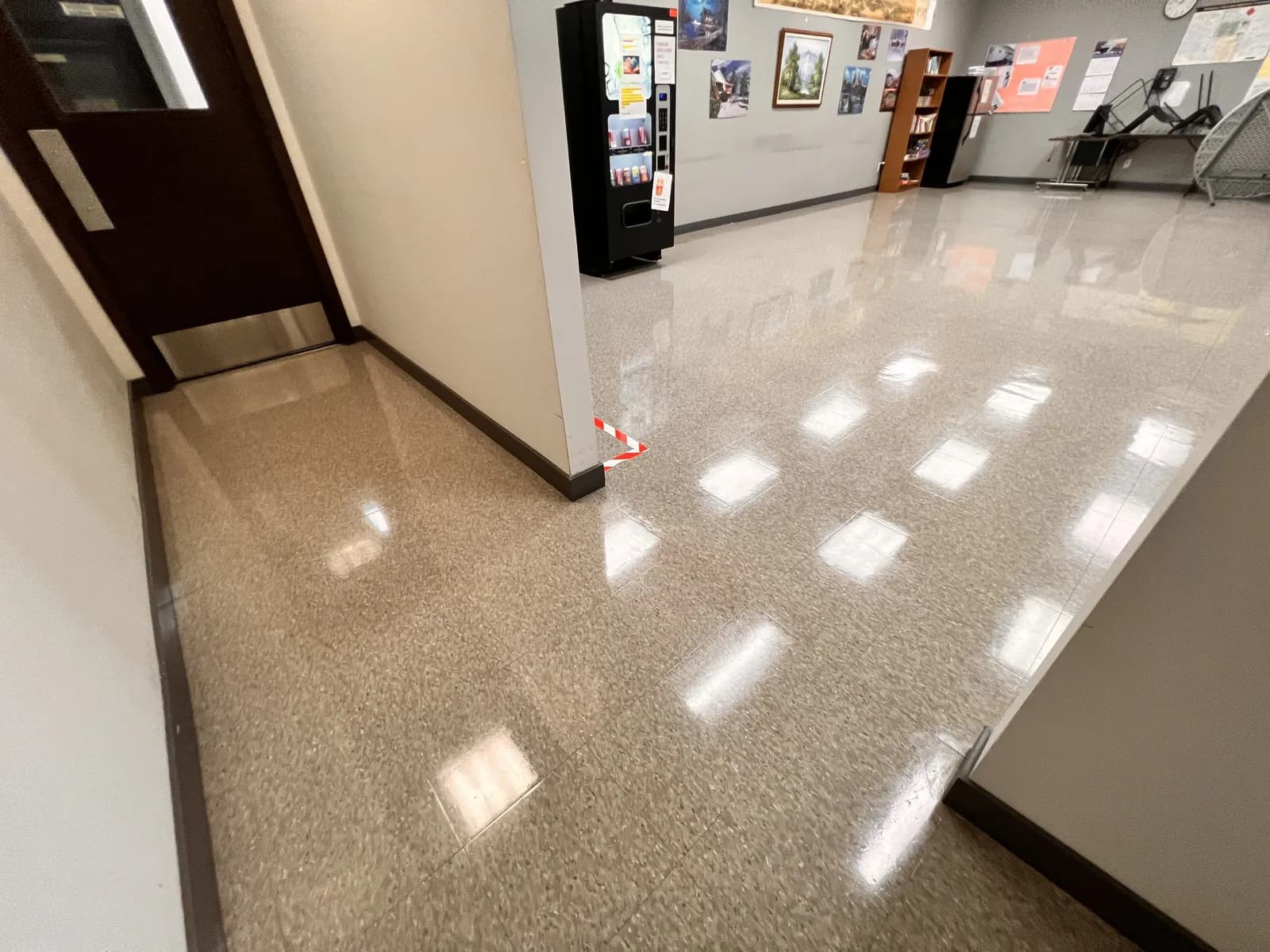 A clean, reflective floor in a commercial corridor.
