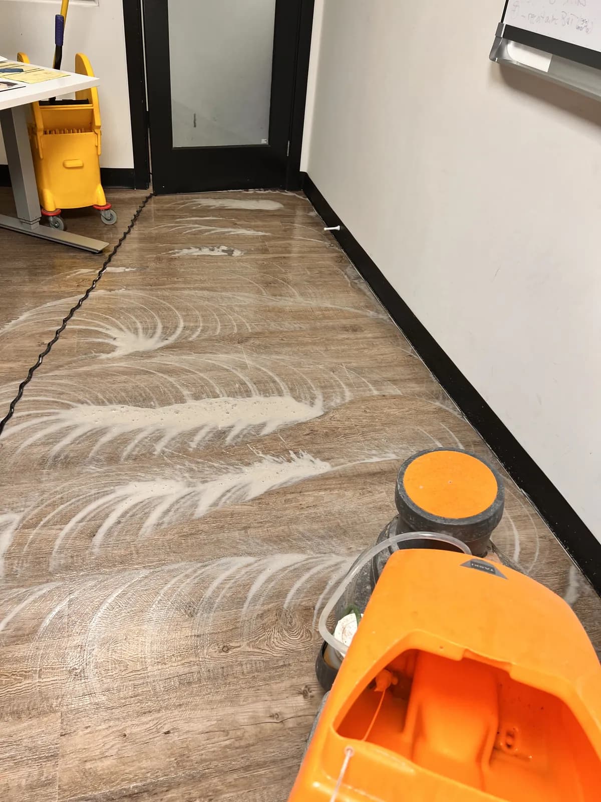 Floor-cleaning equipment working on a commercial floor.