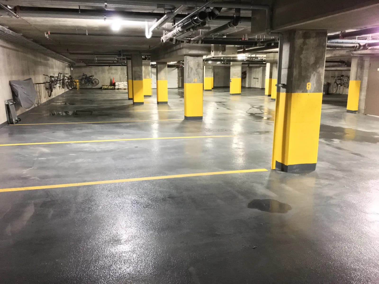 A maintained indoor parking area with marked parking bays.