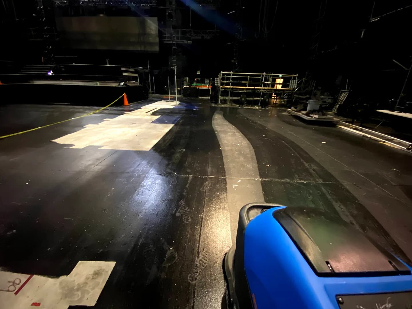 Floor scrubber and stage floor inside the Star Académie studios.
